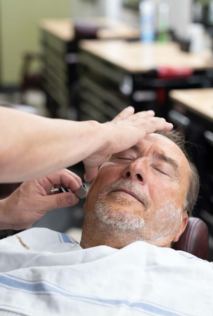 Barber giving a client a straight-razor shave.