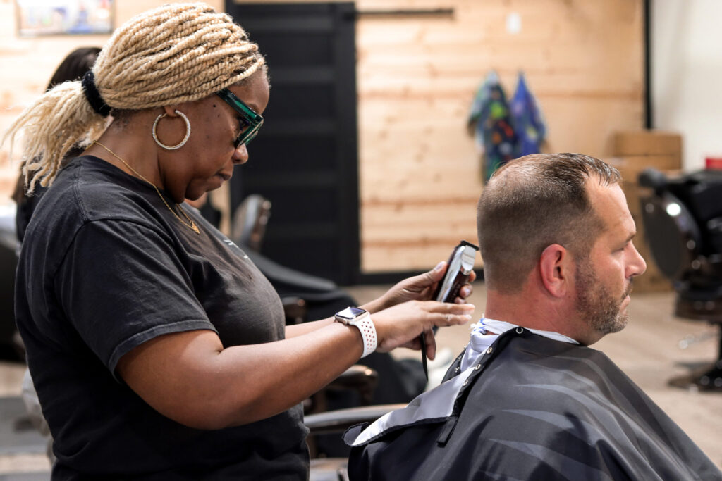 Barber cutting a client’s hair.