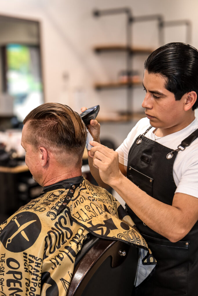 Barber cutting a client’s hair.