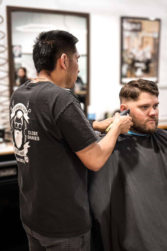 Barber cutting a client’s hair.